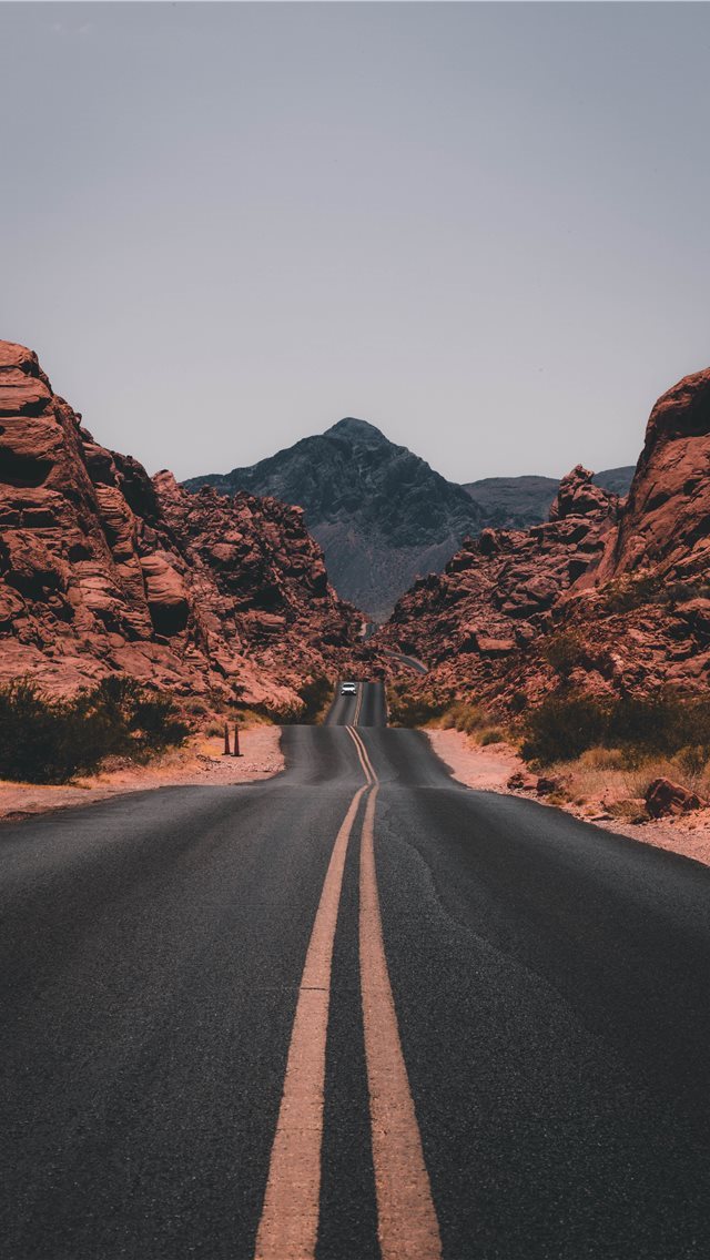 640x1136 black concrete road surrounded by brown rocks - travel iPhone Wallpaper