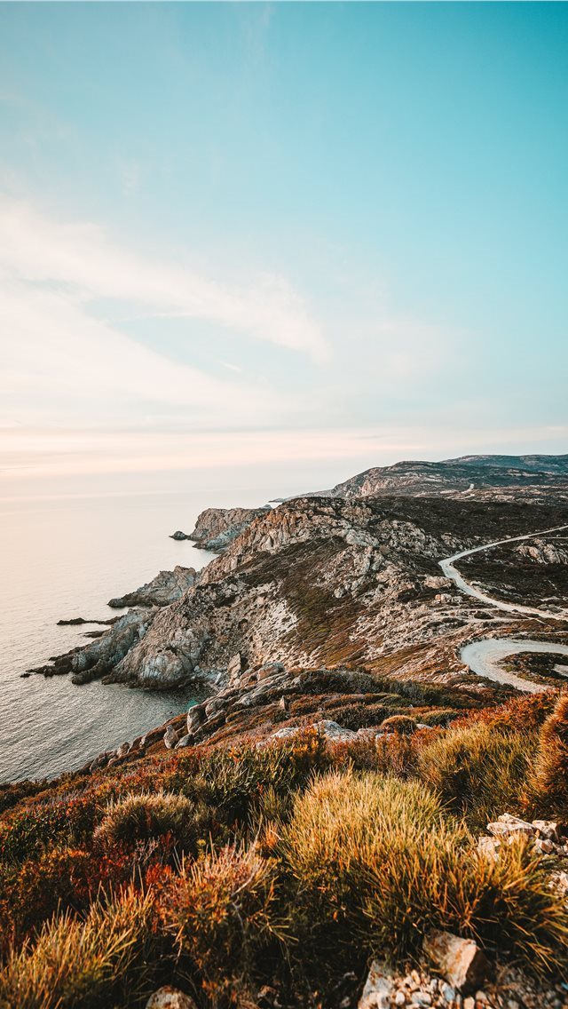 640x1136 rocky cliff facing ocean under blue sky -  iPhone Wallpaper