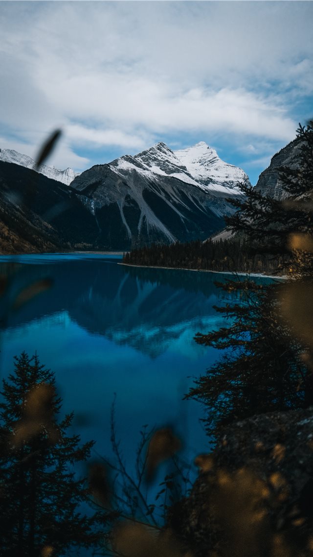 body of water near snow covered mountain during da... iPhone wallpaper 