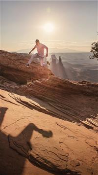 man jumping under sunlight wallpaper