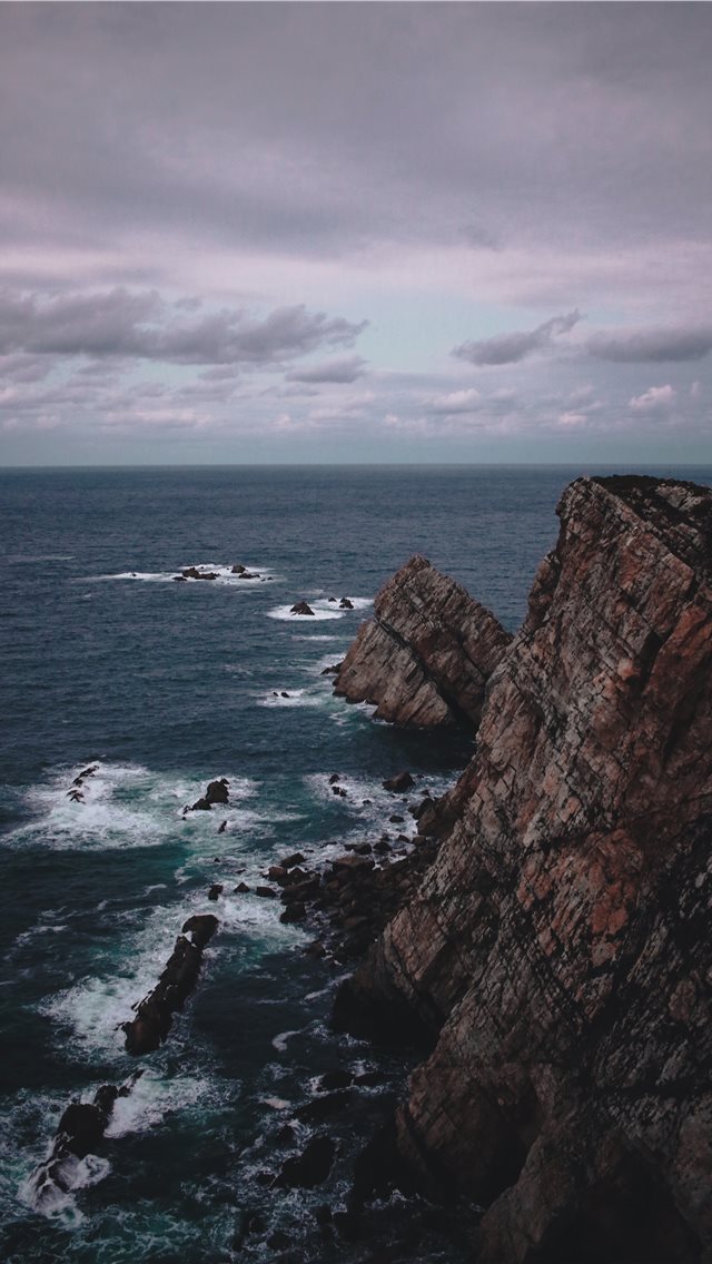 640x1136 rock formation near the sea during daytime - spain iPhone Wallpaper