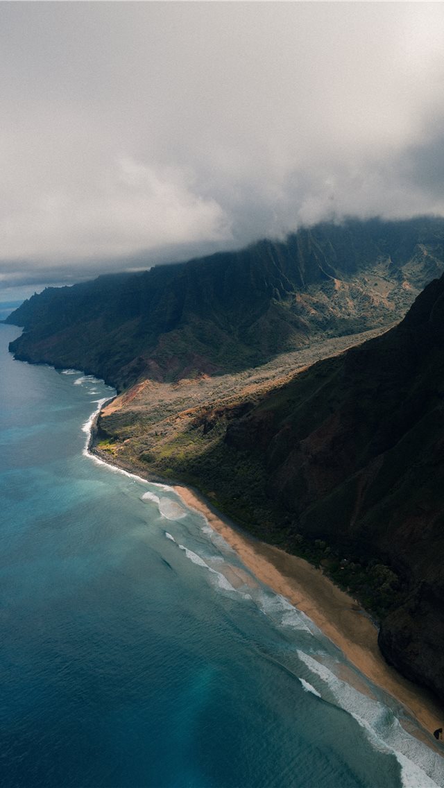 640x1136 green mountain near body of water under grey sky - scenery iPhone Wallpaper