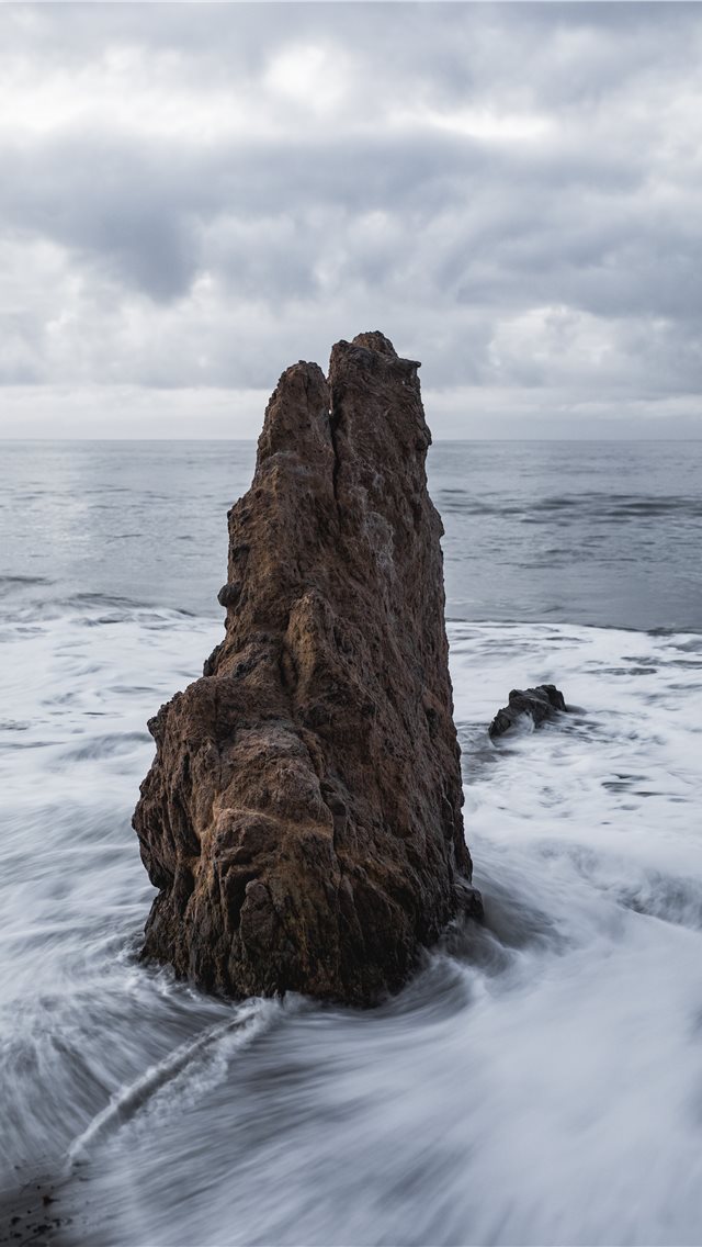 640x1136 brown rock on body of water across horizon - grey iPhone Wallpaper