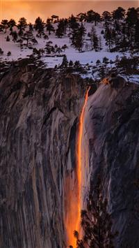 waterfalls near cliff at golden hour wallpaper