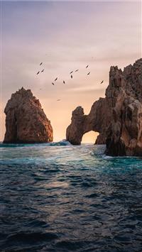 rock formation on the ocean photography wallpaper