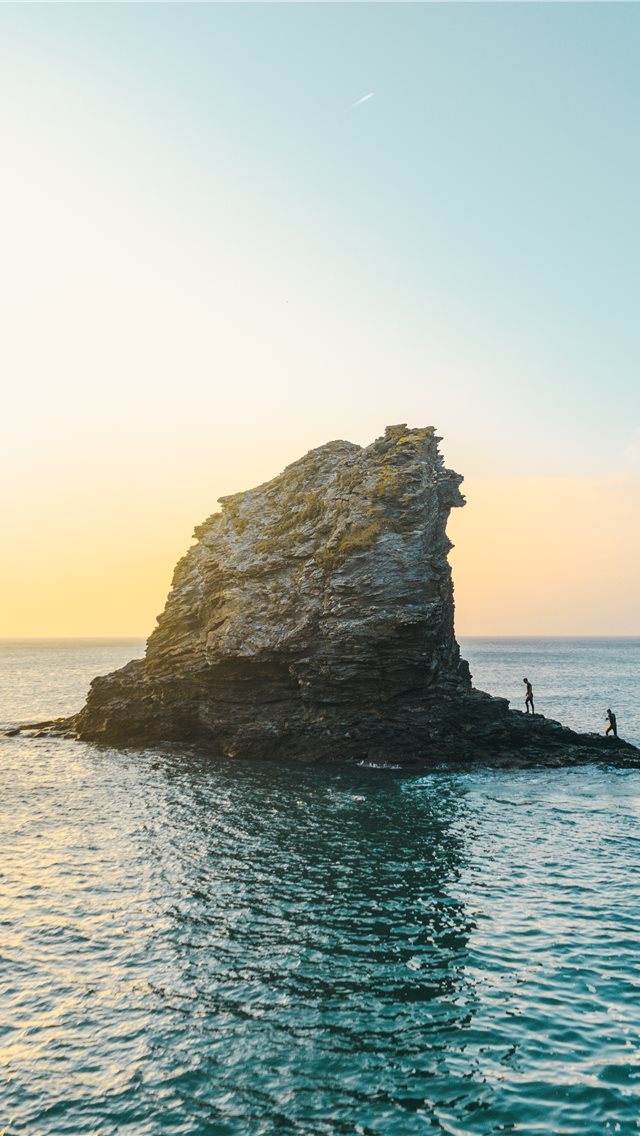 640x1136 two people standing on rock formation surrounded b... - ocean iPhone Wallpaper