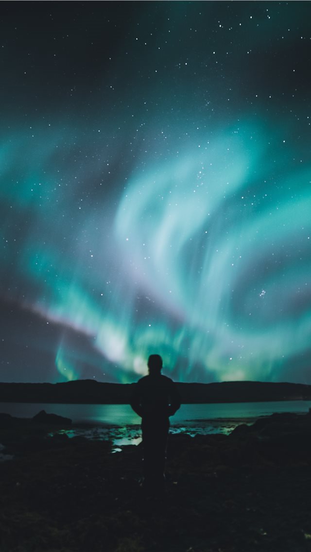 640x1136 person standing on ground under sky lights - iceland iPhone Wallpaper