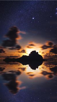 silhouette of islet during golden hour wallpaper