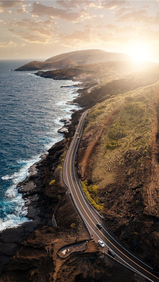 640x1136 vehicles passing on road beside body of water duri... - hawaii iPhone Wallpaper