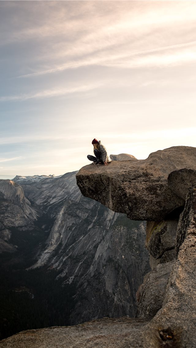 640x1136 person sitting on brown mountain -  iPhone Wallpaper