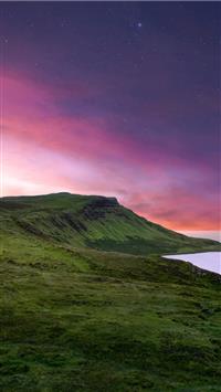 green mountain under purple sky wallpaper