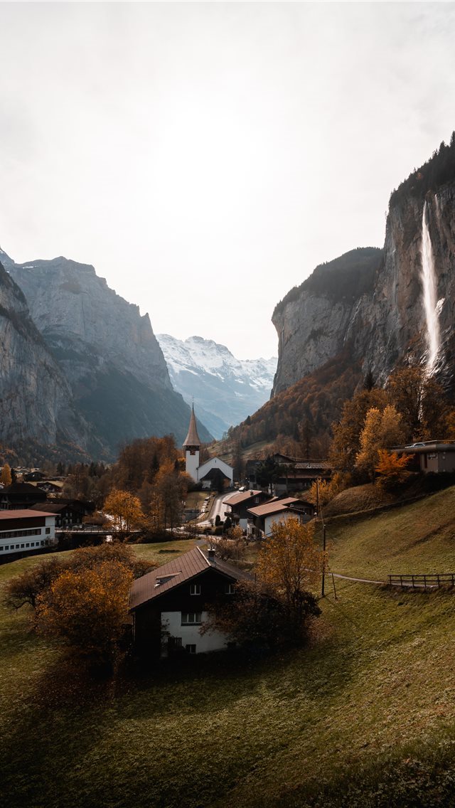 640x1136 brown and white house near mountain during daytime - lauterbrunnen iPhone Wallpaper