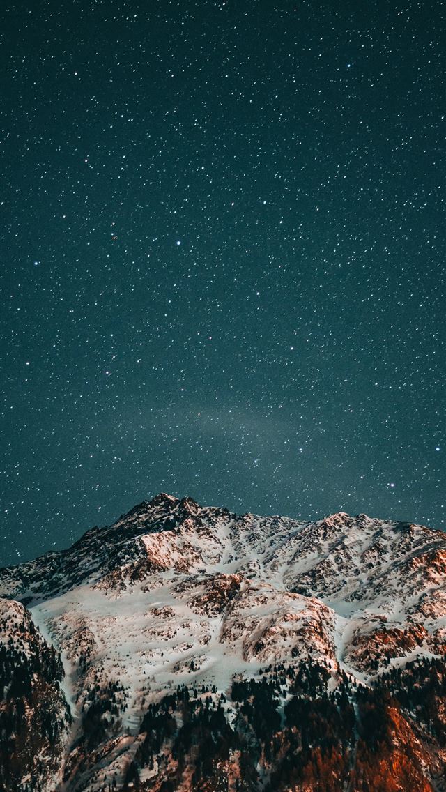 snow covered mountain under starry night iPhone wallpaper 