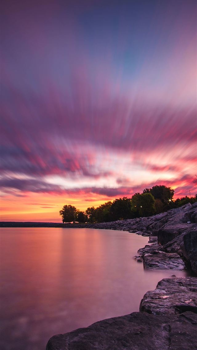 body of water and gray rock formation iPhone wallpaper 