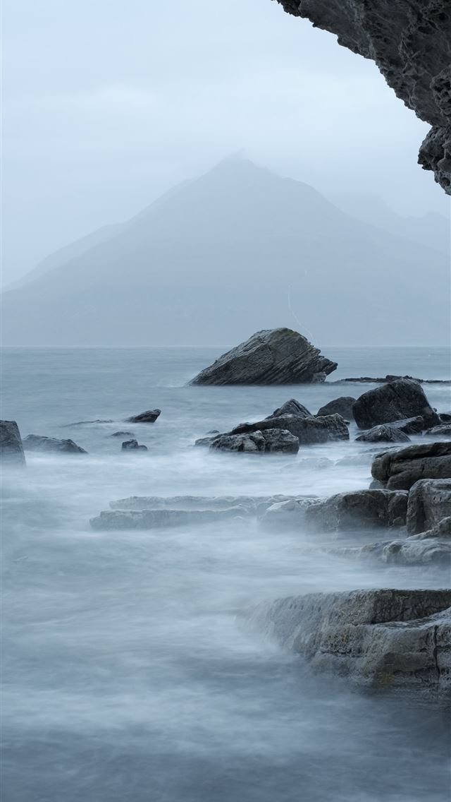 rocky mountain beside body of water during daytime iPhone wallpaper 