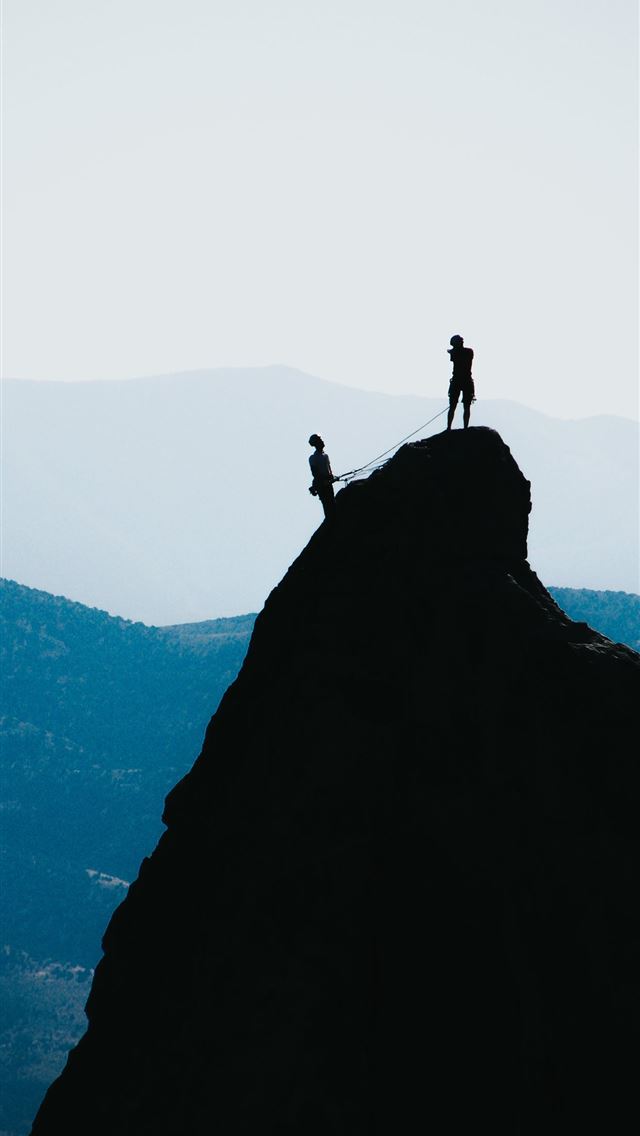 640x1136 silhouette of two people standing on mountain duri... -  iPhone Wallpaper