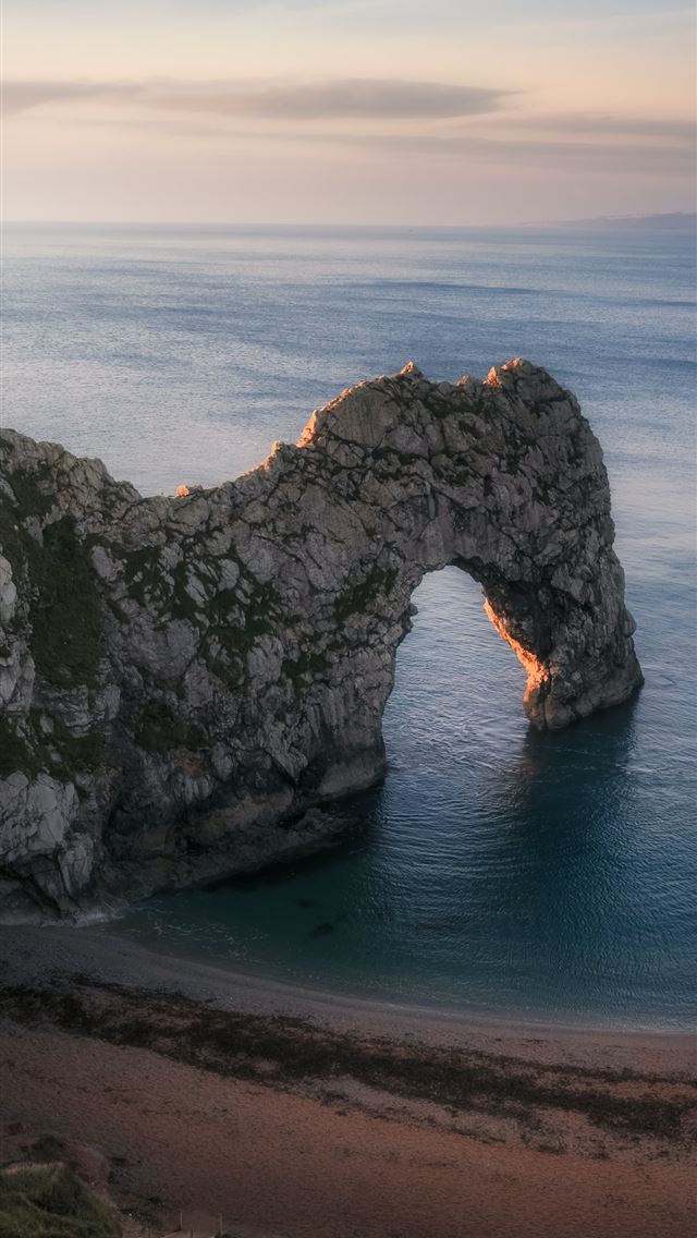 640x1136 high angle photography of cliff and blue beach - england iPhone Wallpaper