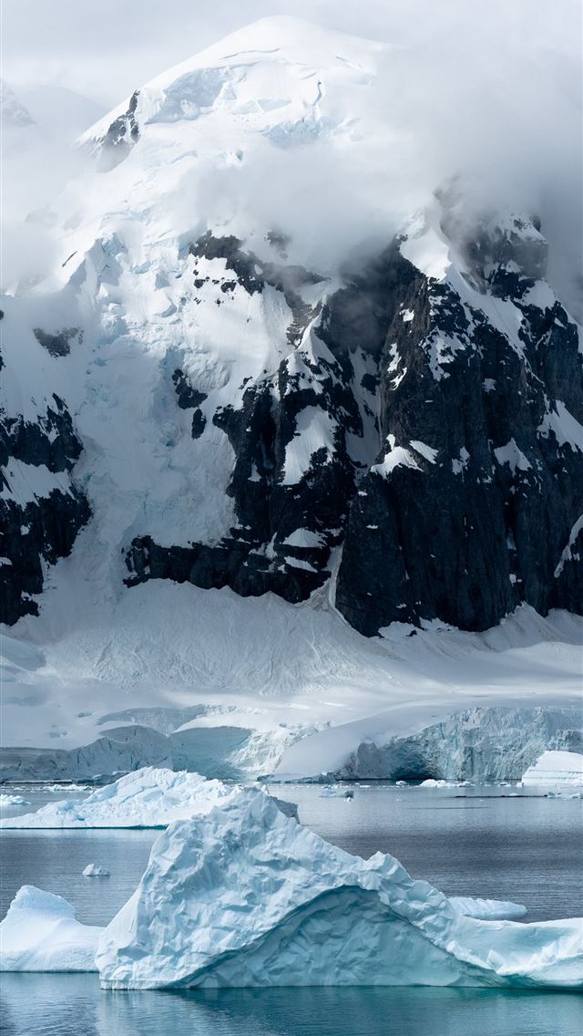 small iceberg beside large iceberg iPhone wallpaper 