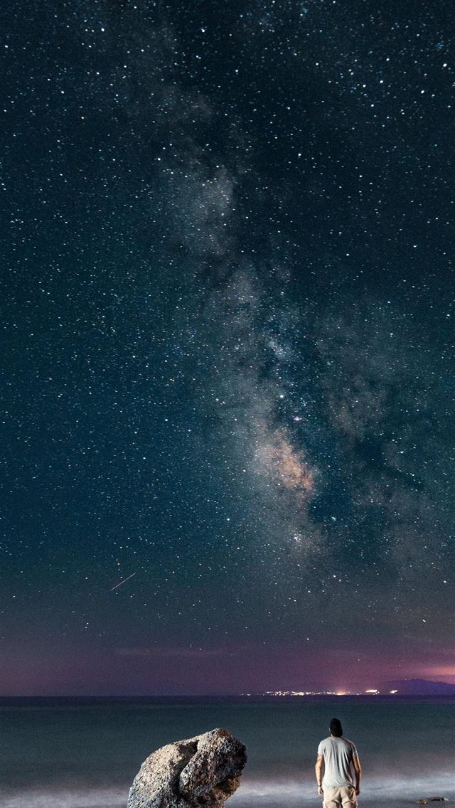 640x1136 man standing near rock viewing calm sea - space iPhone Wallpaper