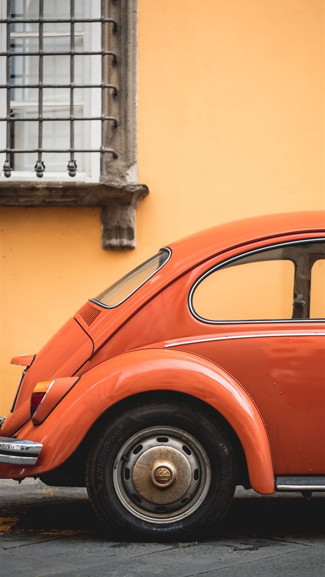 shallow focus photo of orange Volkswagen Beetle iPhone wallpaper 