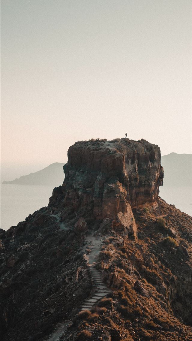 640x1136 brown rock formation on sea during daytime - santorini iPhone Wallpaper