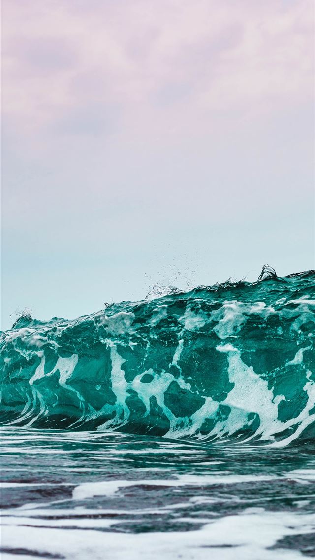 person surfing on sea waves during daytime iPhone wallpaper 