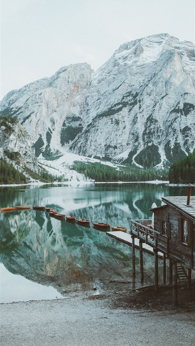 640x1136 brown wooden dock on lake near snow covered mounta... - italy iPhone Wallpaper