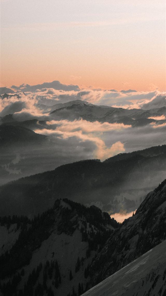 black and white mountains under white clouds durin... iPhone wallpaper 