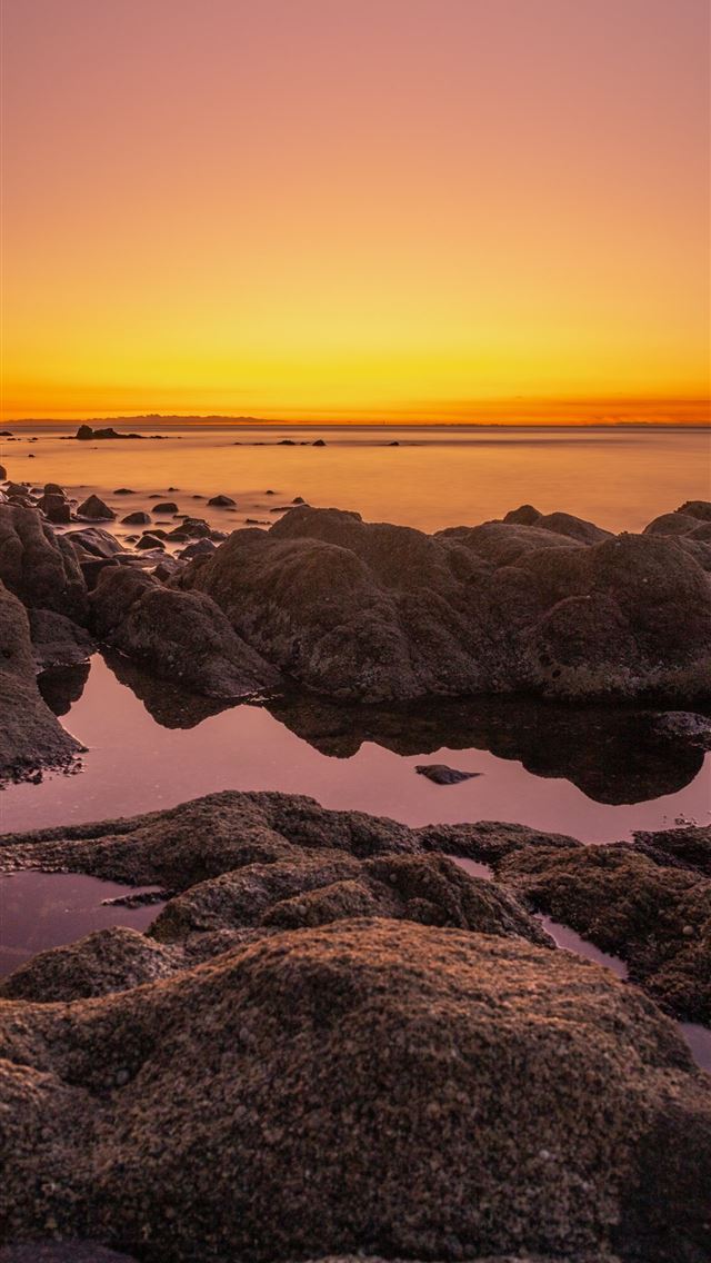 640x1136 rocky shore during sunset with orange sky -  iPhone Wallpaper