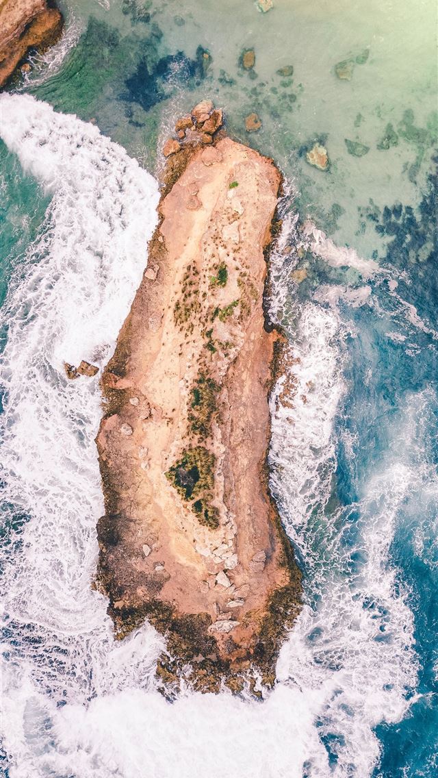 island on body of water during daytime iPhone wallpaper 