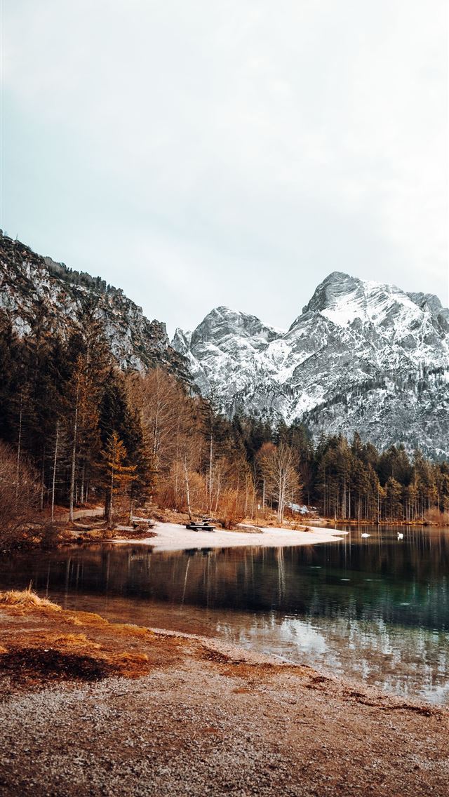 lake surrounded by trees and mountains during dayt... iPhone wallpaper 