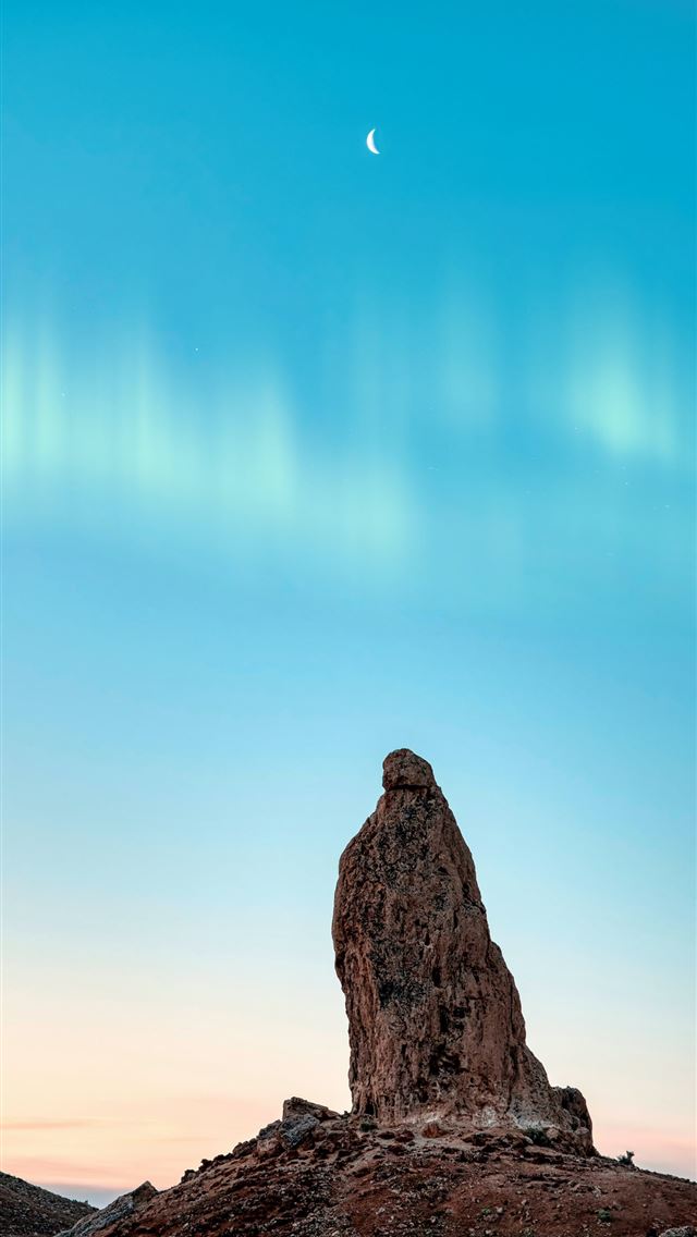 brown rock formation under blue sky during daytime iPhone wallpaper 