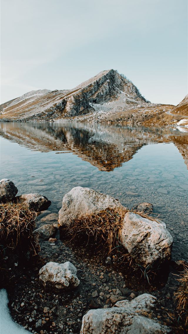 640x1136 brown rocky mountain beside lake under blue sky du... - light iPhone Wallpaper