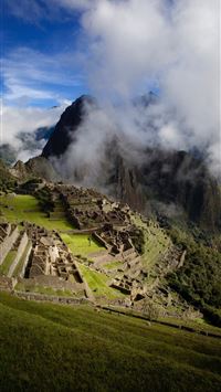 cloudy day overlooking the ruins of machu picchuru... wallpaper