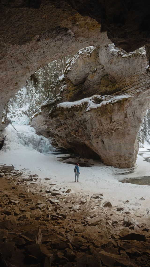 640x1136 person standing between large rock formation fille... - canada iPhone Wallpaper