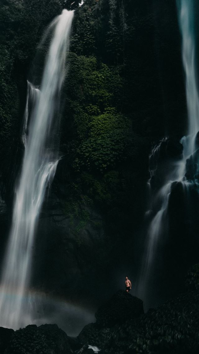 640x1136 people sitting on rock in front of waterfalls duri... - indonesia iPhone Wallpaper