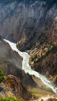 aerial photography of flowing body of water betwee... wallpaper