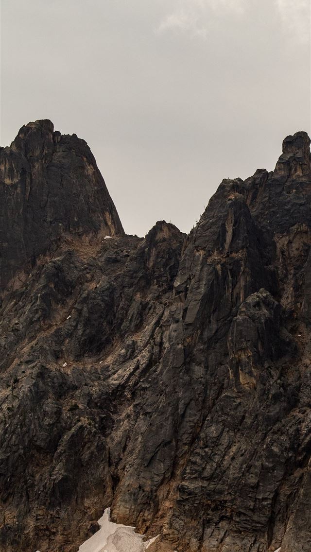 640x1136 gray rock hill under blue sky - trees iPhone Wallpaper