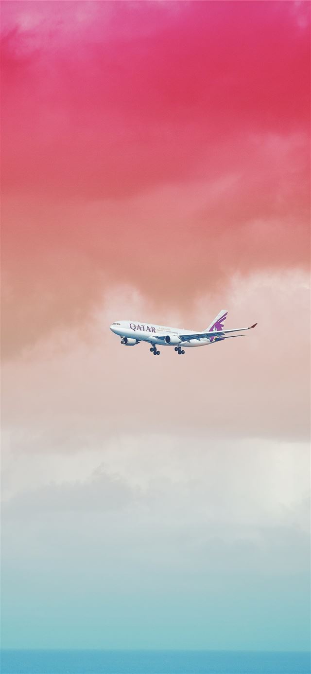 1125x2436 Qatar Airlines airplane flying under red cloud for... - maldives iPhone X Wallpaper