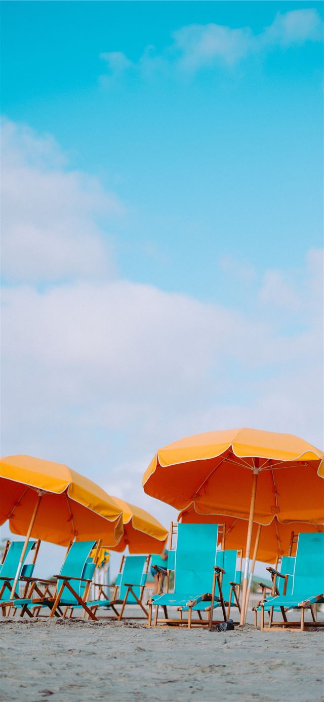 1125x2436 closeup photo of lounger chairs and beach umbrella... - orange iPhone X Wallpaper