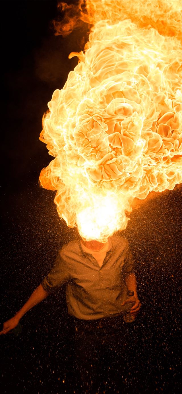 1125x2436 man spitting fire - yellow iPhone X Wallpaper