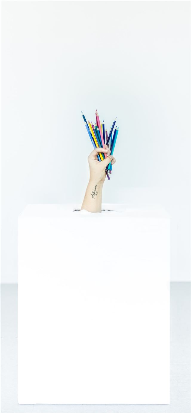 1125x2436 person's hand burst out of box holding assorted co... -  iPhone X Wallpaper