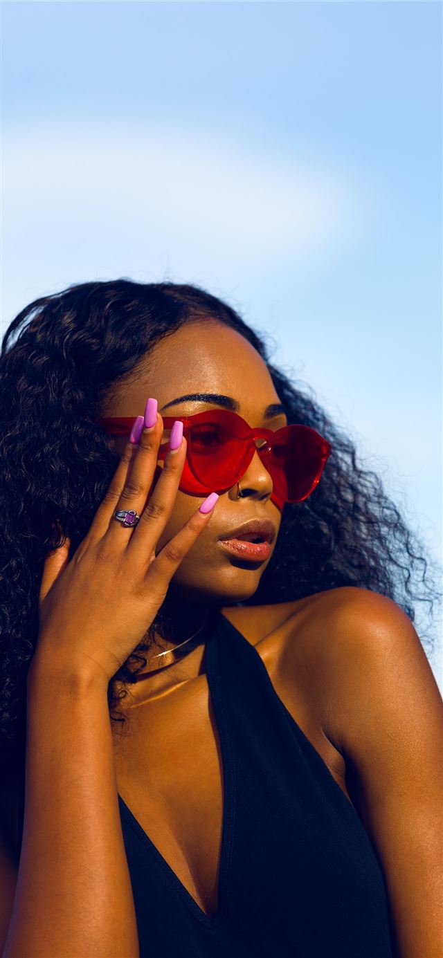 1125x2436 woman holding her sunglasses - black iPhone X Wallpaper