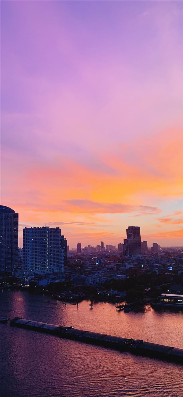 1125x2436 city skyline across body of water during sunset - water iPhone X Wallpaper
