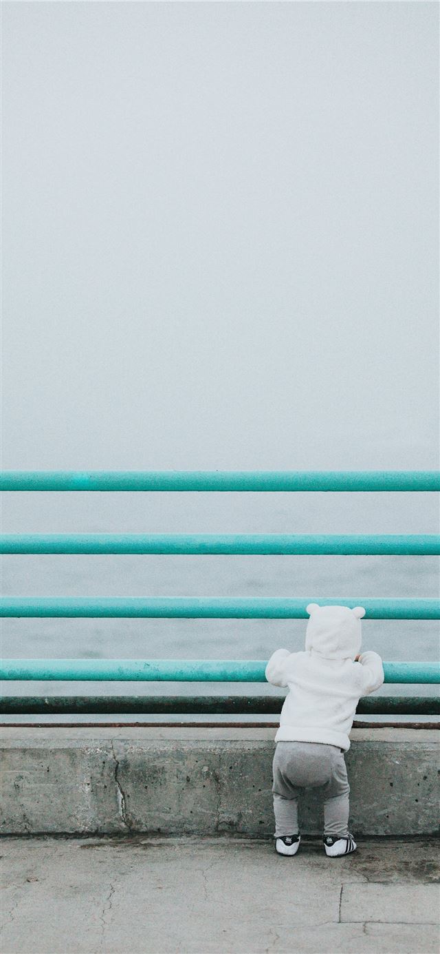 1125x2436 toddler standing while resting arm on rail facing ... -  iPhone X Wallpaper