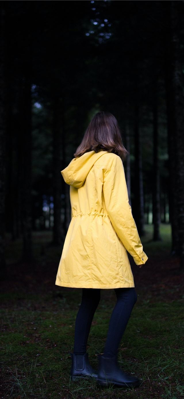 1125x2436 woman standing near green leafed trees - cyan iPhone X Wallpaper