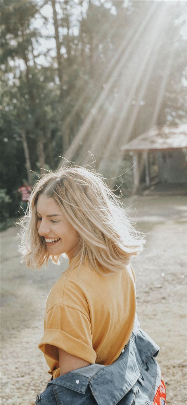 1125x2436 woman walking in white sand during daytime -  iPhone X Wallpaper