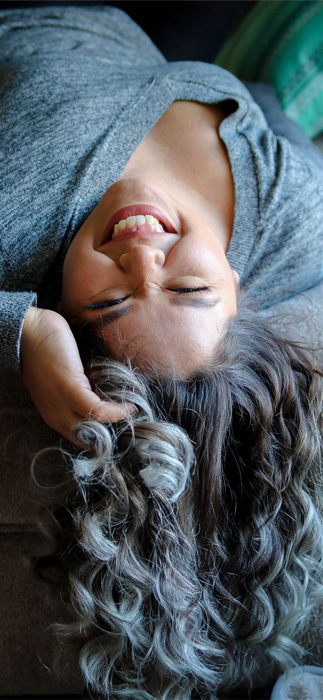 1125x2436 woman laying on couch near throw pillow -  iPhone X Wallpaper
