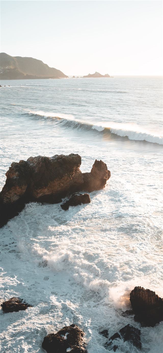 1125x2436 seawaves near mountain - water iPhone X Wallpaper