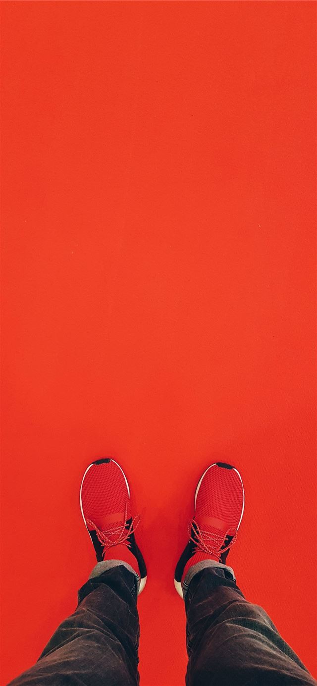 1125x2436 person wearing red running shoe - germany iPhone X Wallpaper